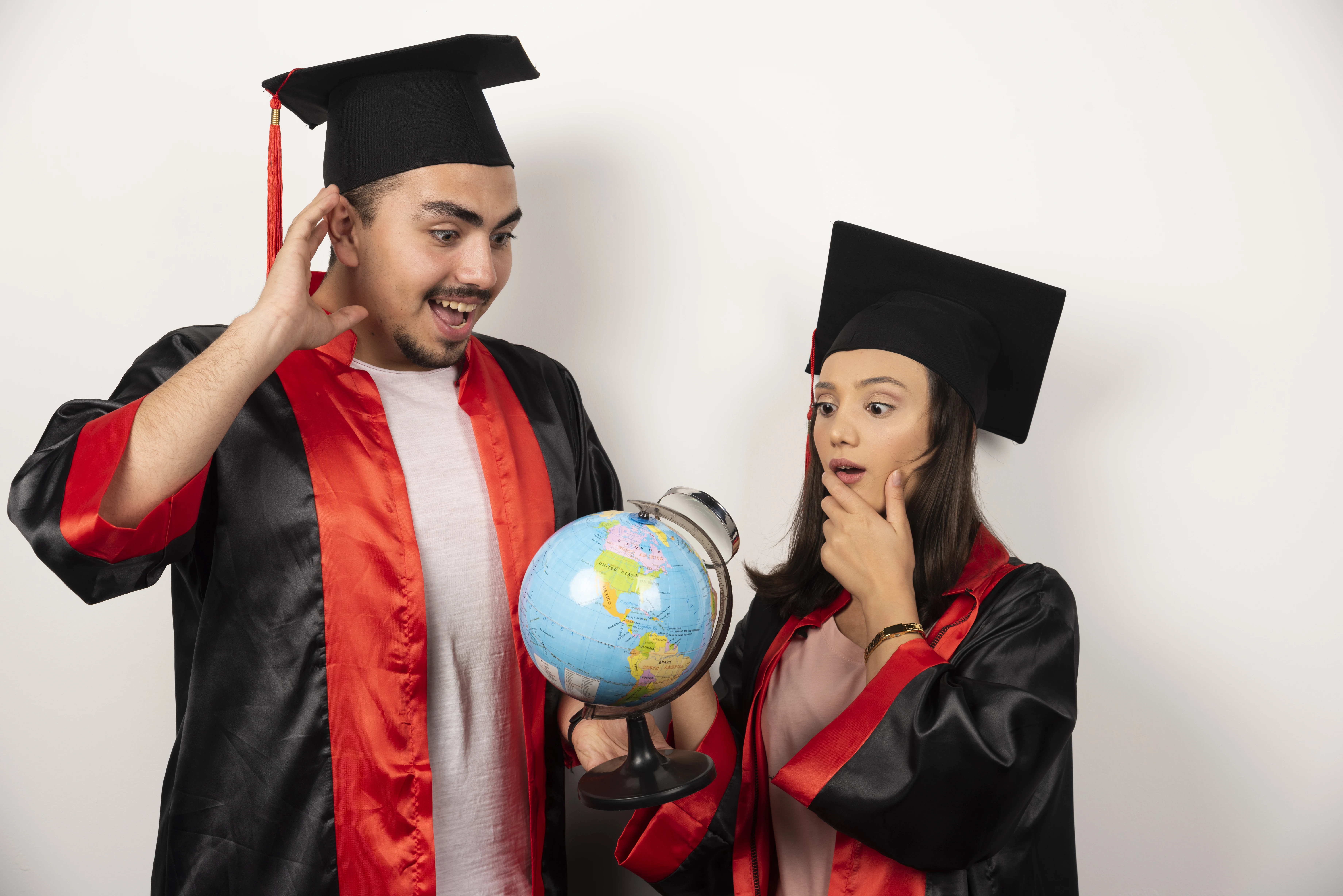 Happy graduates with globe